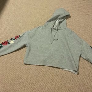 grey copped hoodie floral design on sleeve